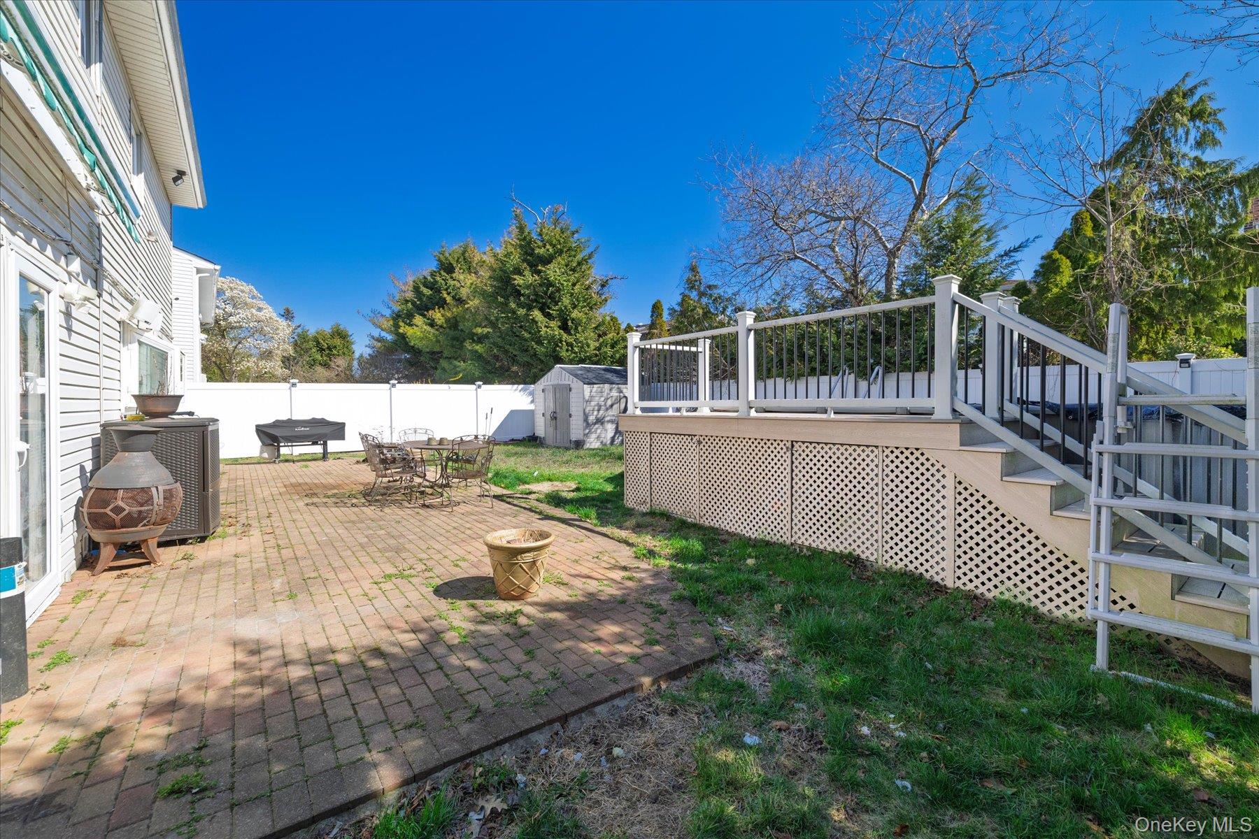 3447 Steven Road Baldwin, NY 11510 - Photo 17 of 23 a view of backyard with a chair under an umbrella