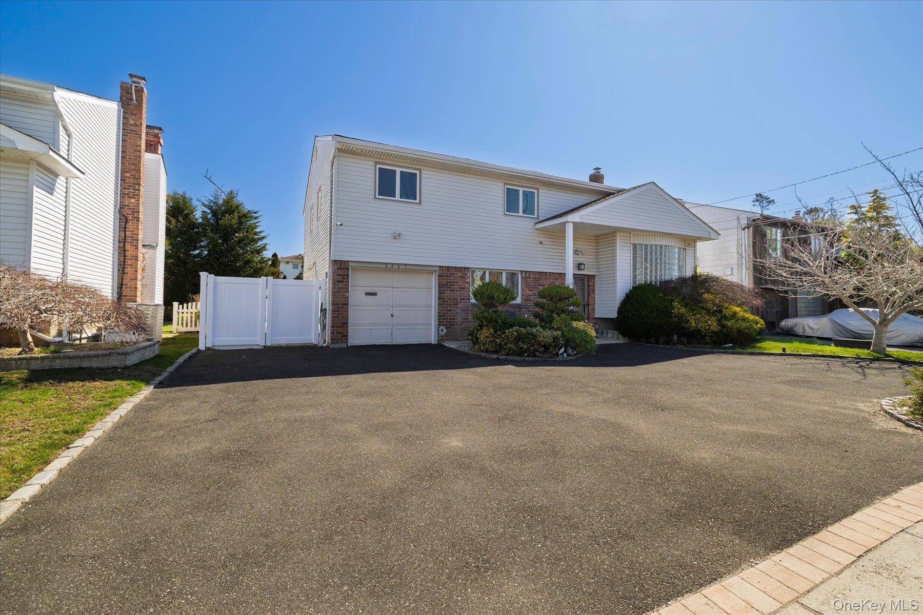 3447 Steven Road Baldwin, NY 11510 - Photo 2 of 23 a front view of a house with garden