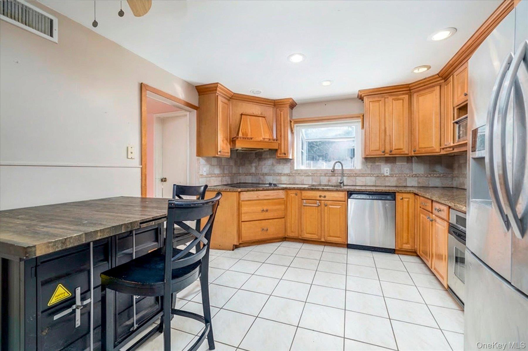3447 Steven Road Baldwin, NY 11510 - Photo 5 of 23 a kitchen with stainless steel appliances granite countertop a stove a sink dishwasher and cabinets