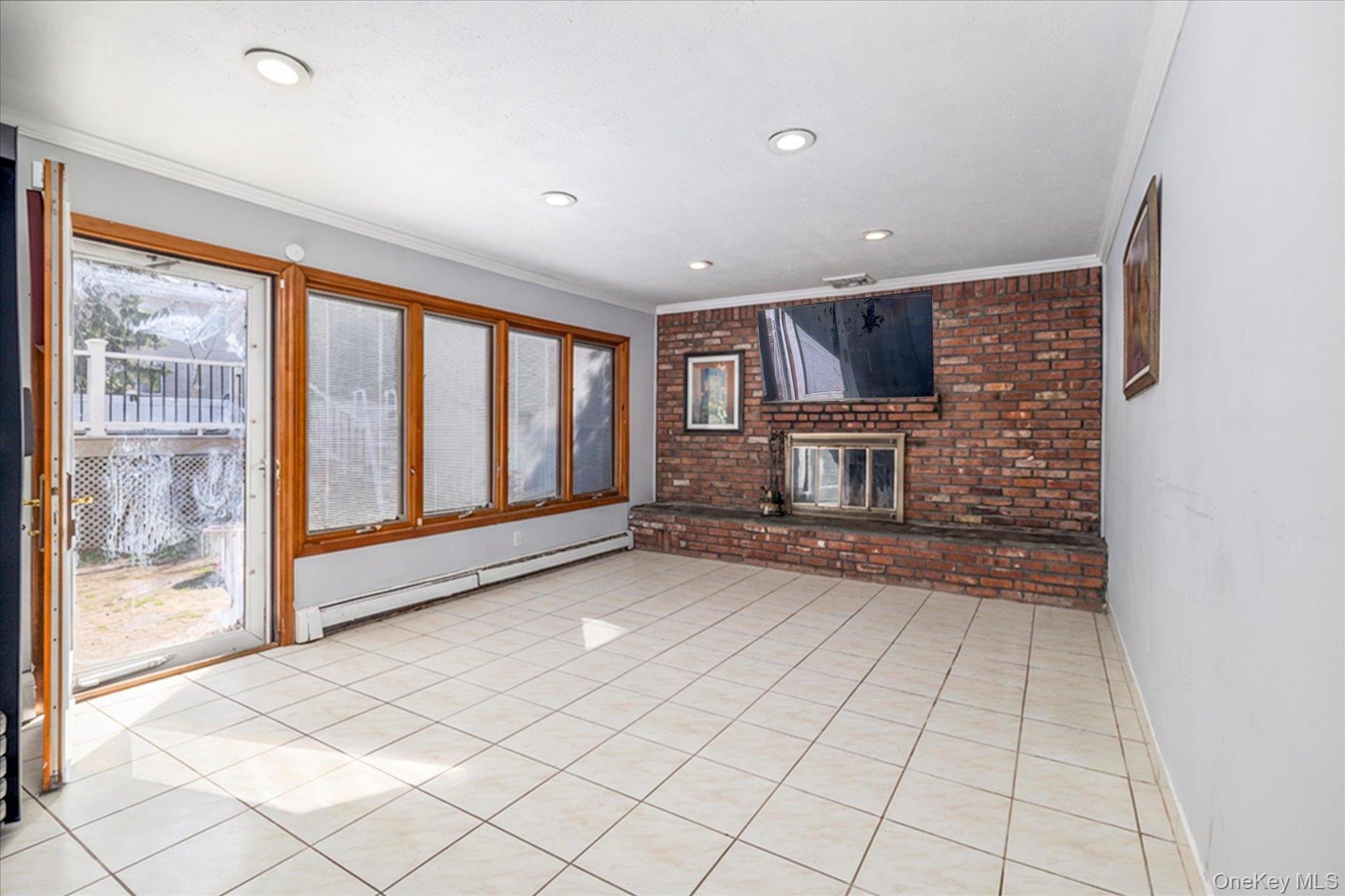 3447 Steven Road Baldwin, NY 11510 - Photo 8 of 23 a view of an empty room with a fireplace and window