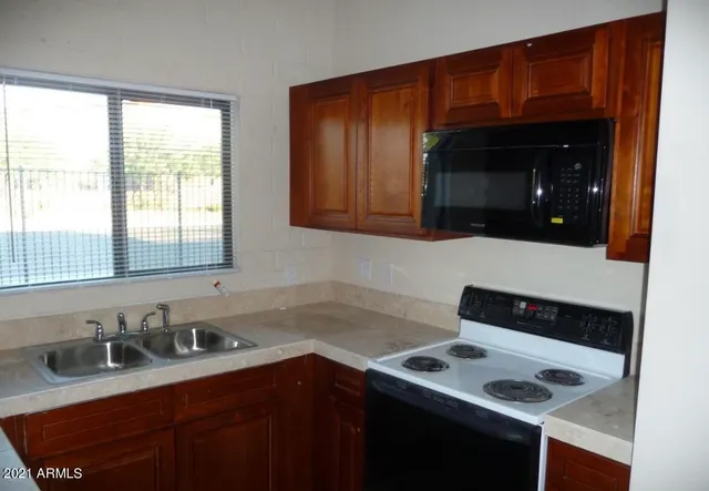 a kitchen with a sink cabinets and window
