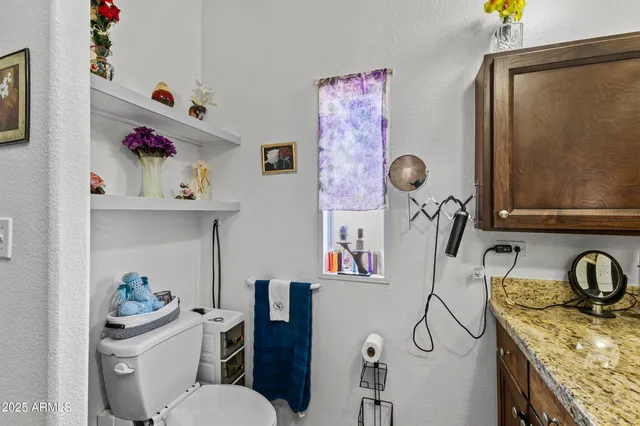 a bathroom with a granite countertop double vanity sink mirror and vanity