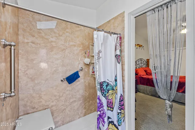 a bathroom with a granite countertop toilet sink and mirror