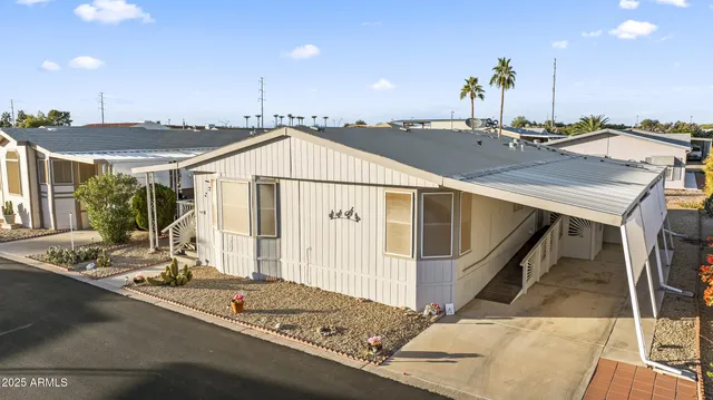 a view of a house with a backyard and a garage
