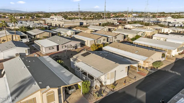 an aerial view of a residential building with parking