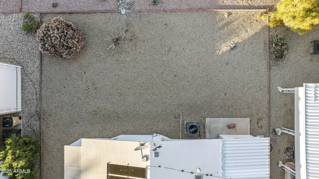 an aerial view of a residential building with parking