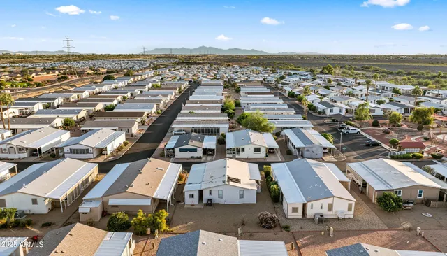 an aerial view of a city with lots of residential buildings and ocean view