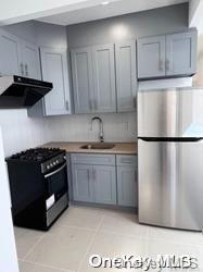108-19 35th Avenue Queens, NY 11368 - Photo 7 of 7 a kitchen with stainless steel appliances granite countertop a stove a refrigerator and a stove