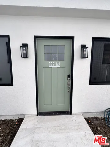 a living room with a flat screen tv and a rug