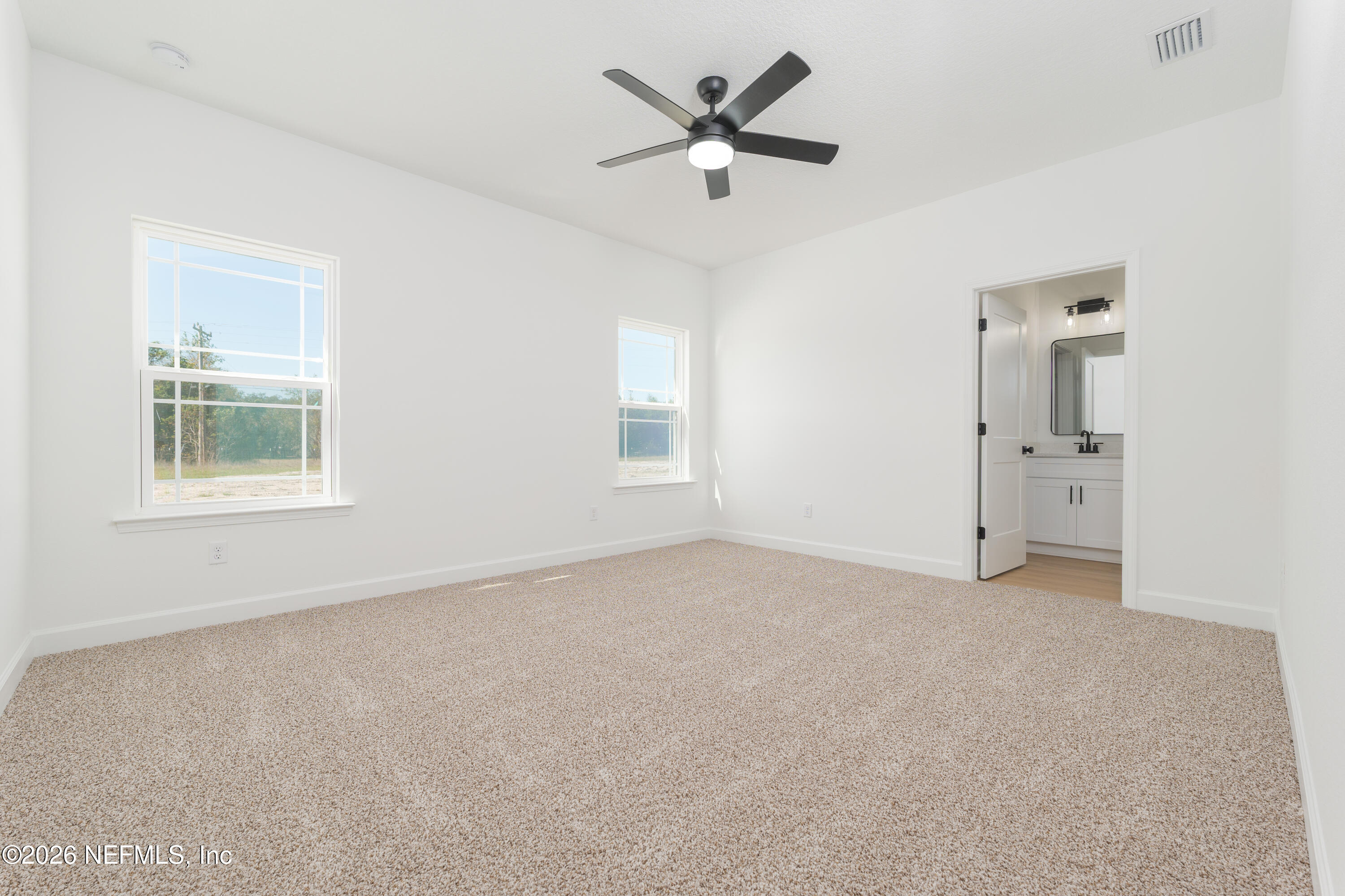 5573 Oregon Trail Middleburg, FL 32068 - Photo 11 of 26 an empty room with a window and a fan
