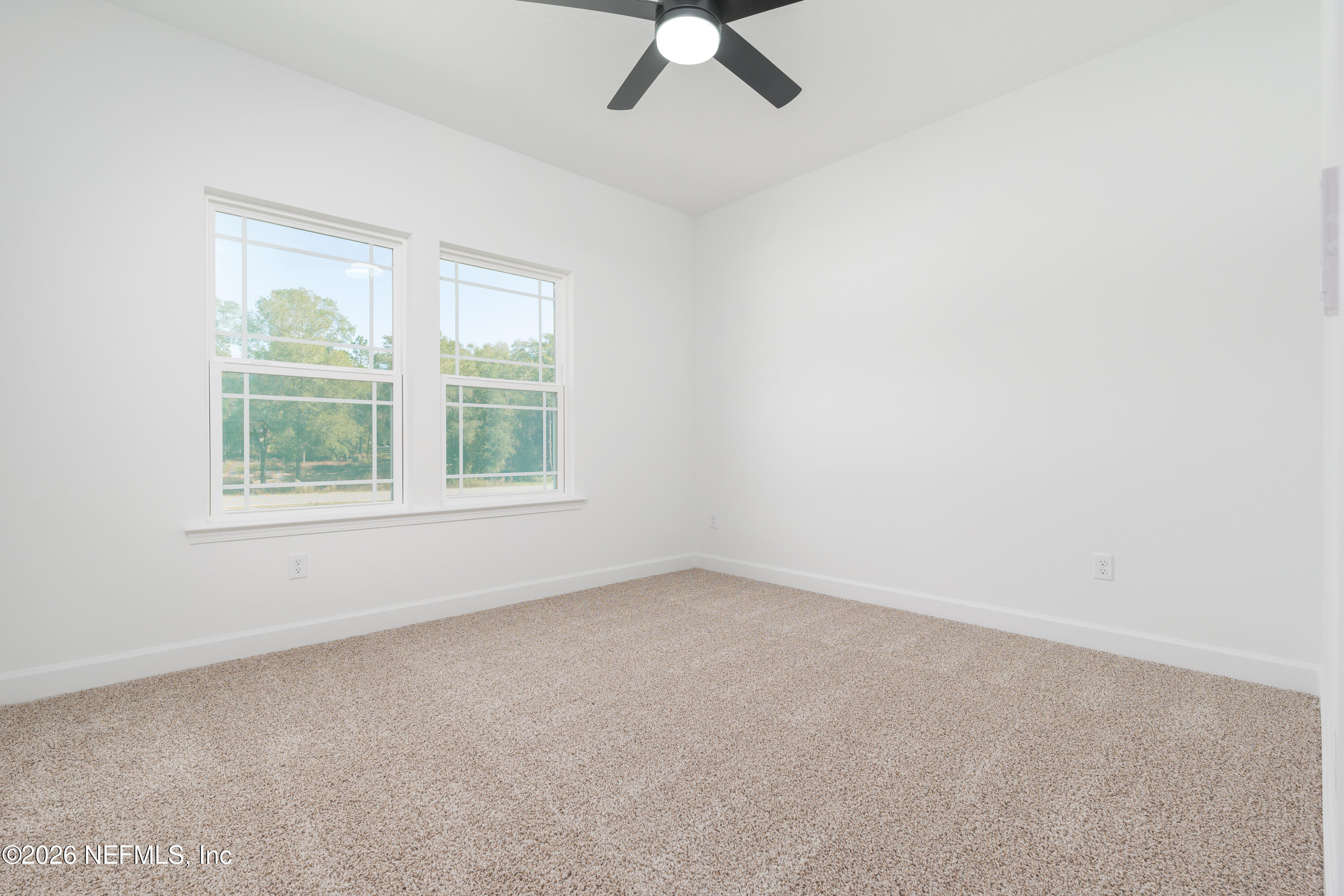5573 Oregon Trail Middleburg, FL 32068 - Photo 16 of 26 an empty room with a window and a fan