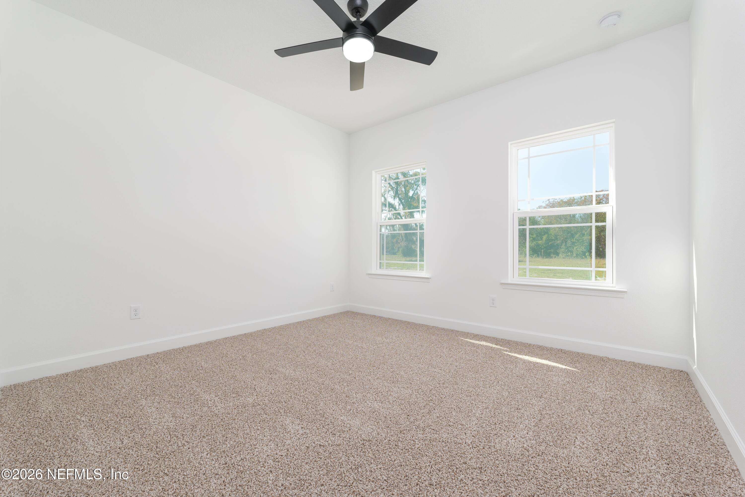 5573 Oregon Trail Middleburg, FL 32068 - Photo 17 of 26 an empty room with windows and fan