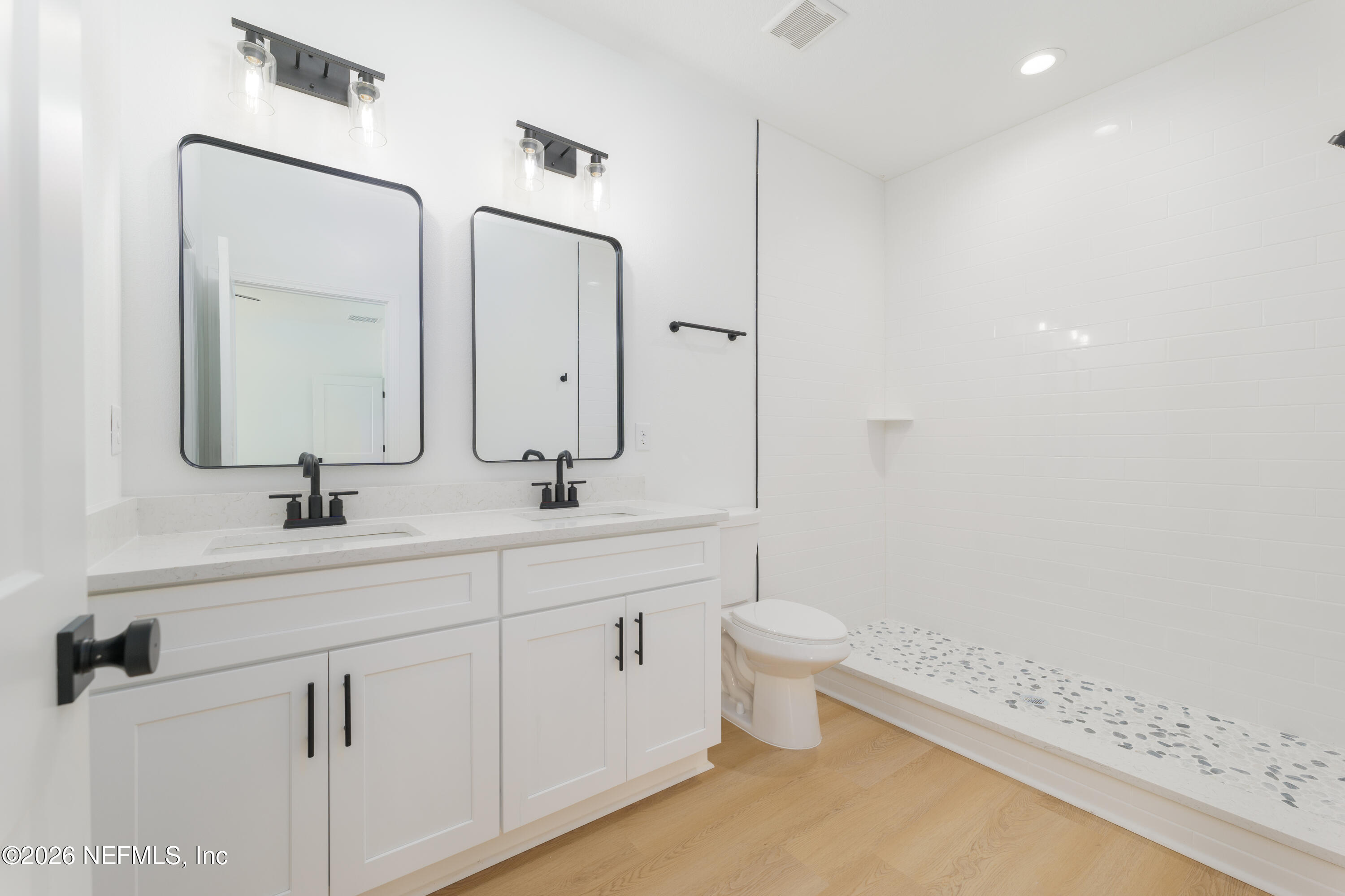 5573 Oregon Trail Middleburg, FL 32068 - Photo 19 of 26 a bathroom with a double vanity sink mirror and toilet