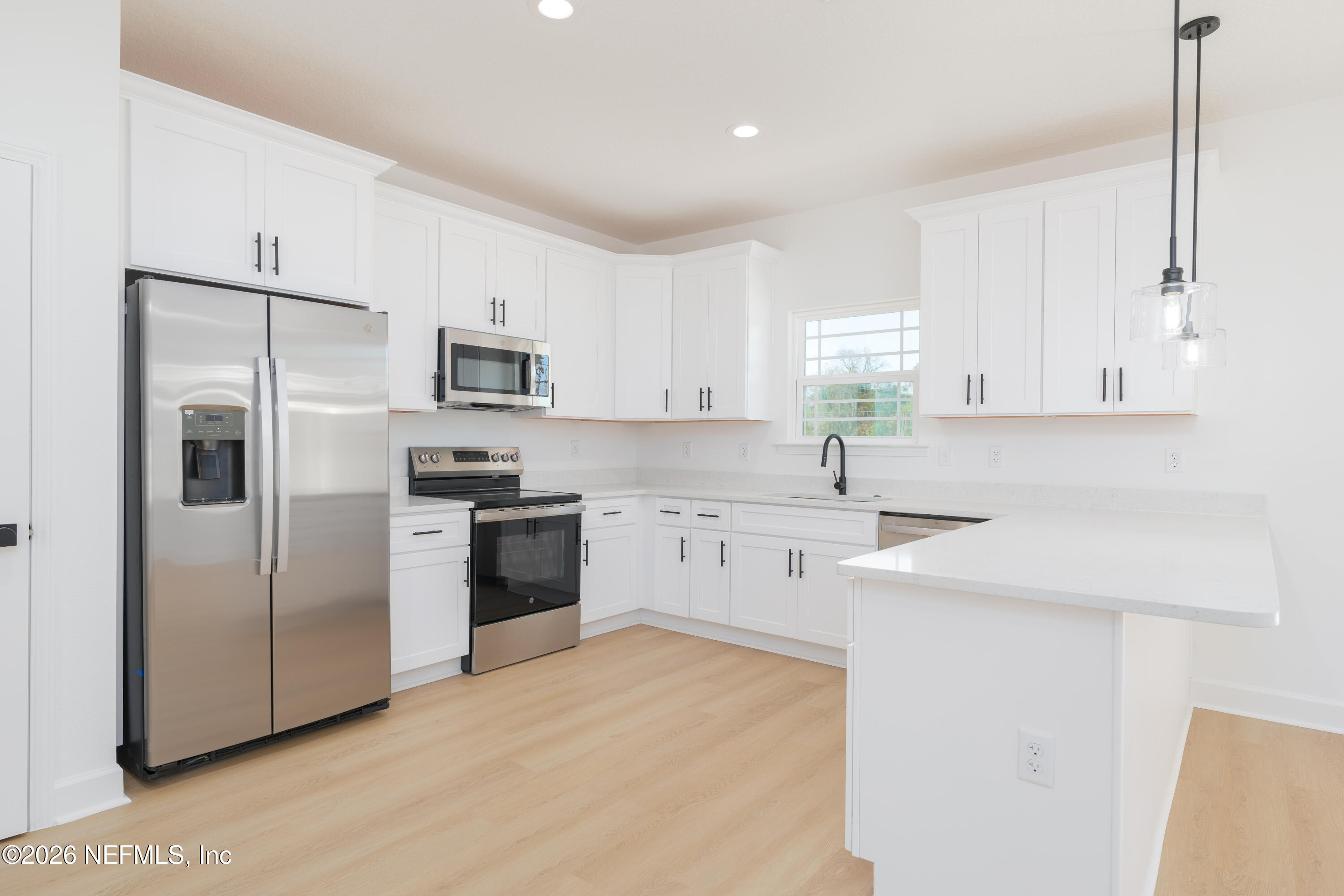 5573 Oregon Trail Middleburg, FL 32068 - Photo 6 of 26 a kitchen with a refrigerator sink and microwave