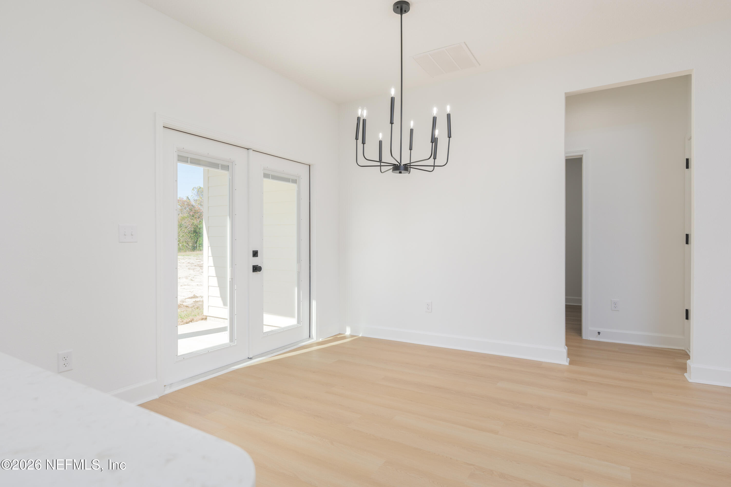 5573 Oregon Trail Middleburg, FL 32068 - Photo 10 of 26 a view of empty room with window and chandelier fan
