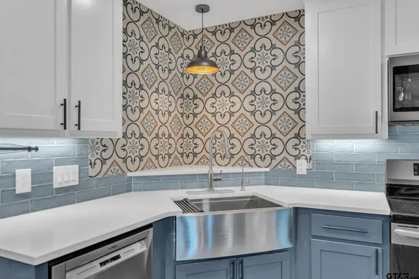a kitchen with a sink a stove and cabinets