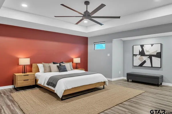 a bedroom with a bed and a chandelier