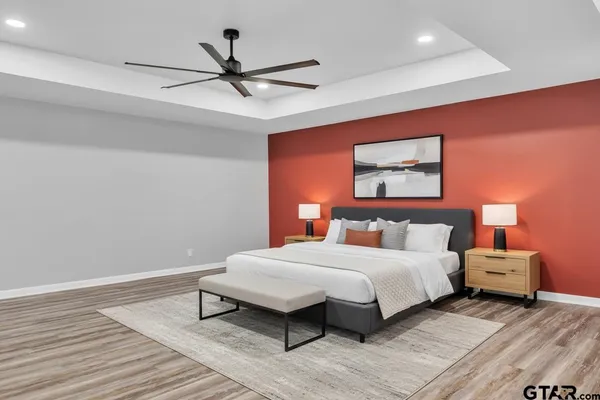 a bedroom with a bed and a ceiling fan