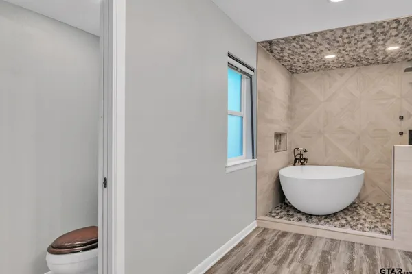 a spacious bathroom with a granite countertop sink and a mirror