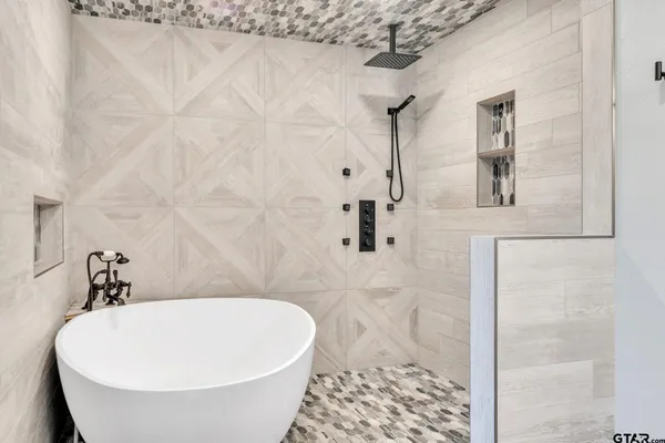 a bathroom with a bathtub and shower