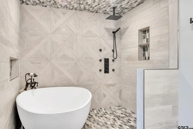 a bathroom with a bathtub and shower