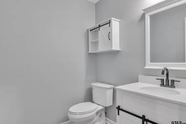 a white toilet sitting next to a bathroom sink