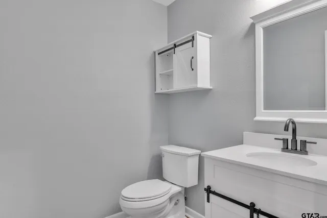 a white toilet sitting next to a bathroom sink