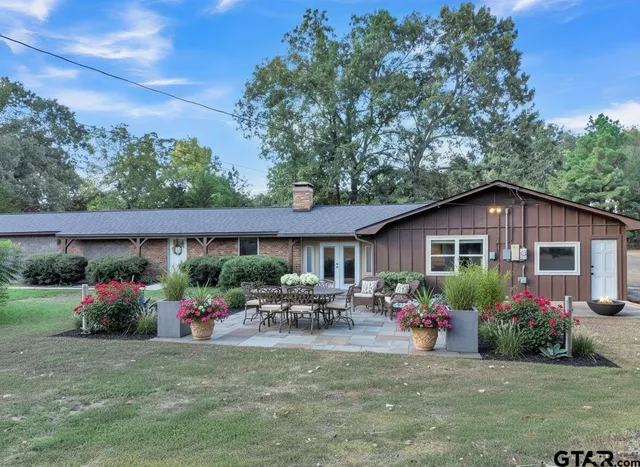 a group of people sitting in front of a house