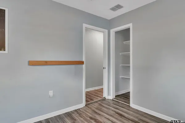 a view of room with wooden floor