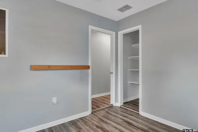 a view of room with wooden floor