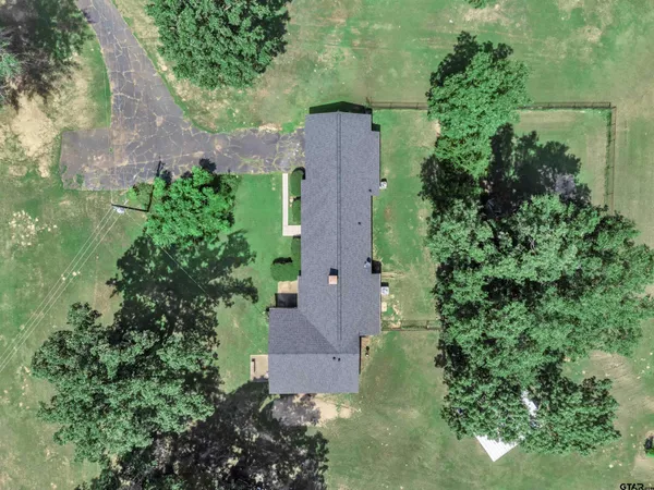an aerial view of a house by greenery space