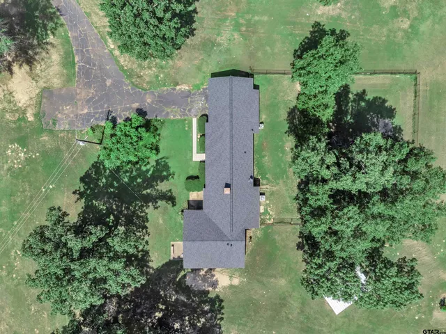 an aerial view of a house by greenery space