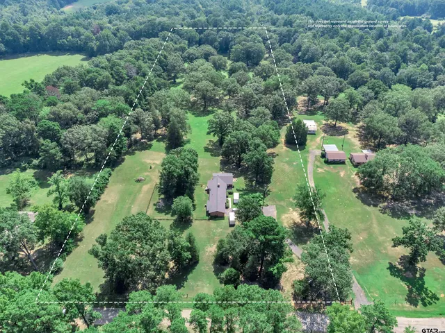 an aerial view of a house with yard