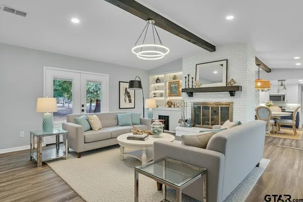 a living room with fireplace furniture and a large window