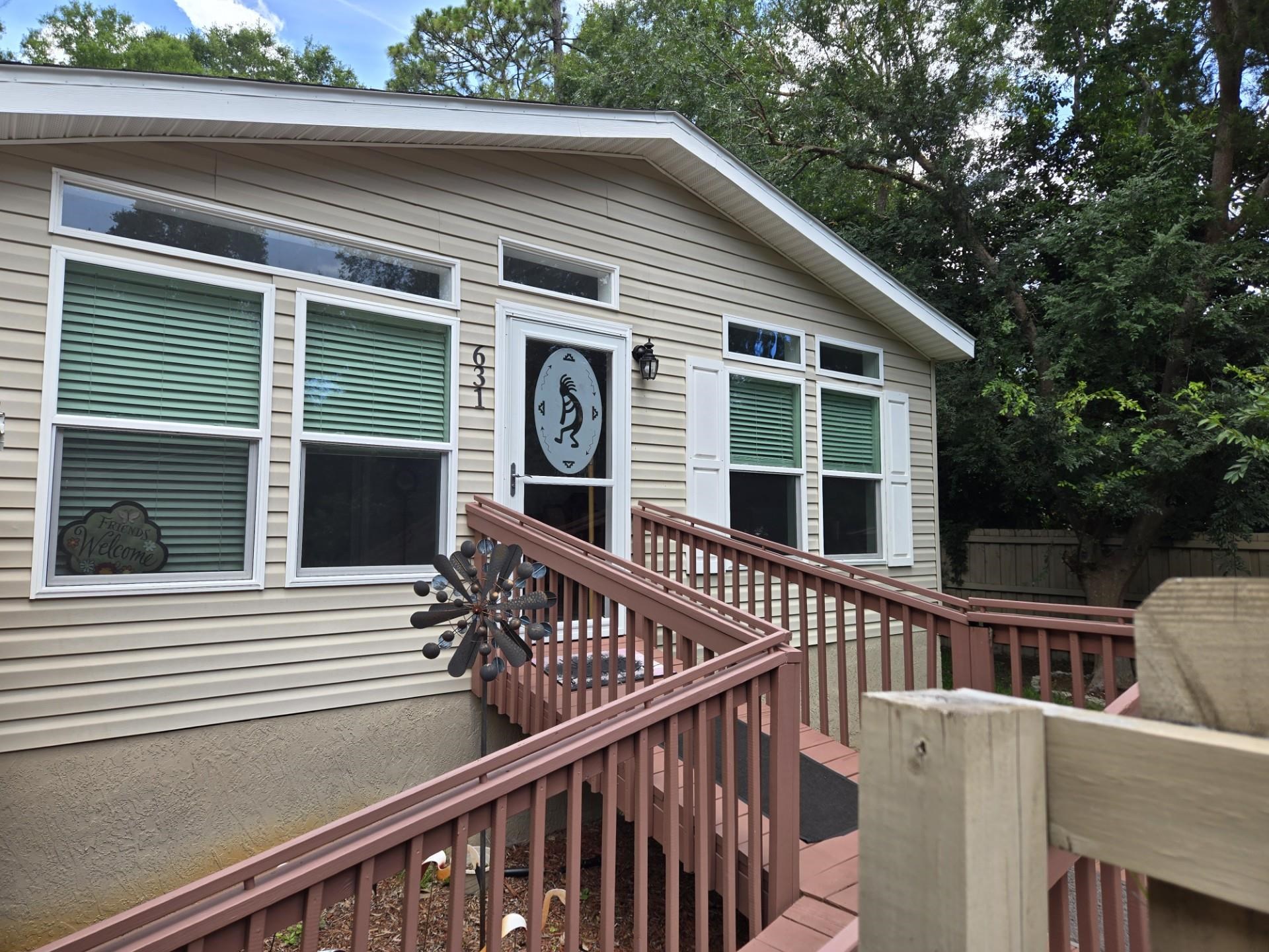 a view of a house with pool and wooden fence