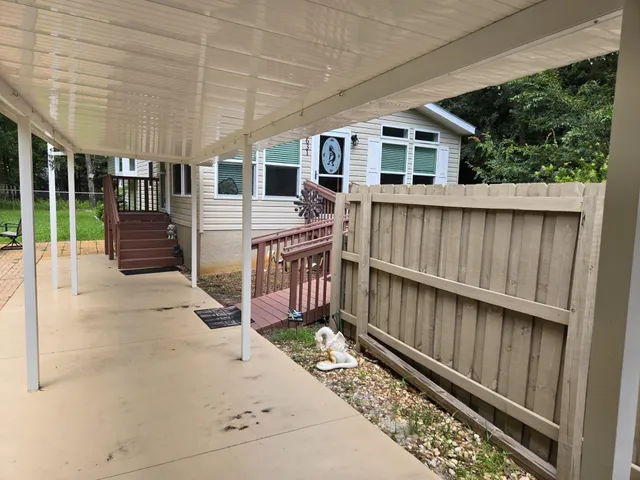 a view of a house with wooden floor roof and wooden fence