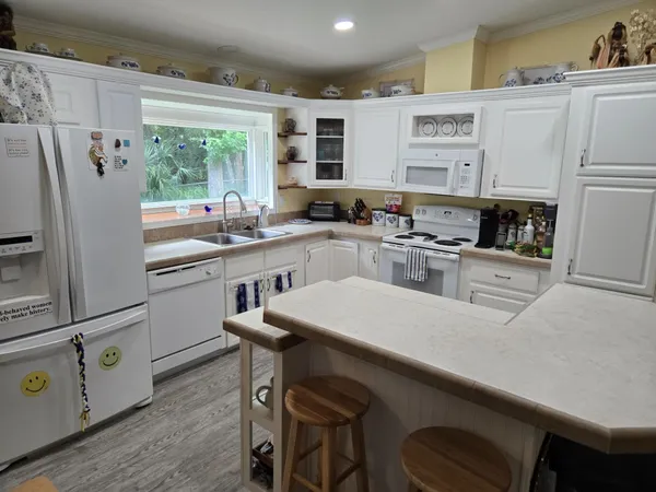 a kitchen with appliances a sink and cabinets