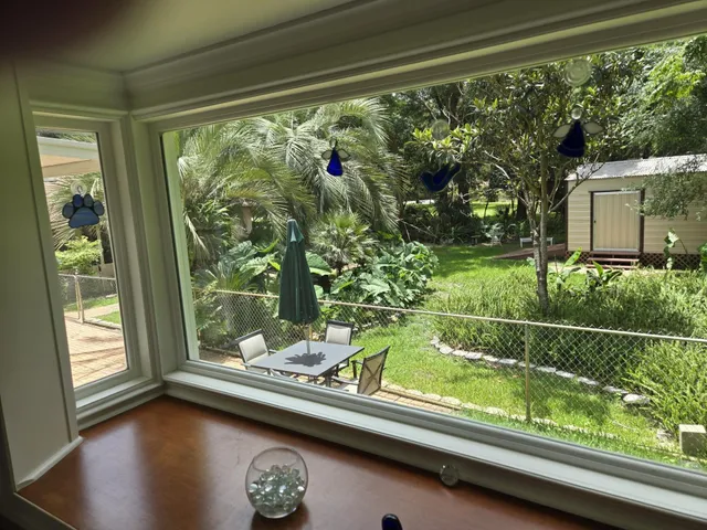 a view of backyard with green space and seating area