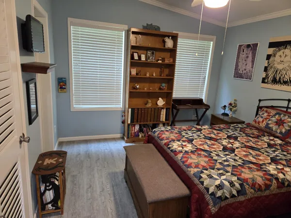 a bedroom with a bed dresser and a window