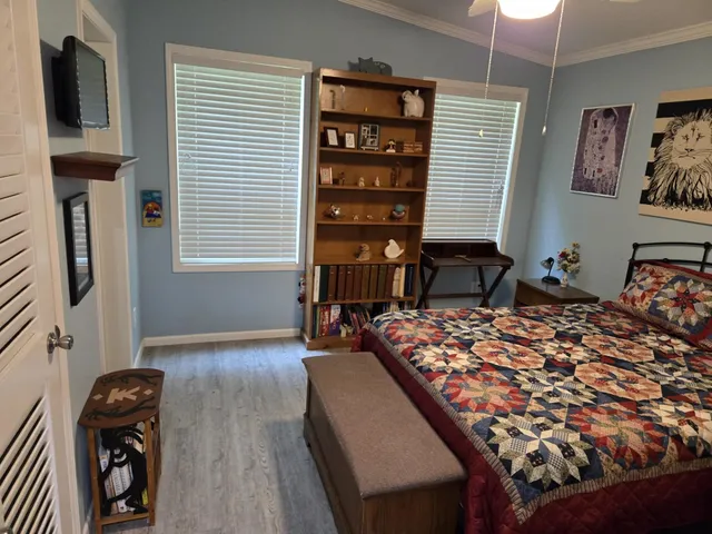 a bedroom with a bed dresser and a window
