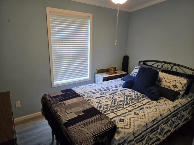 a bedroom with a bed and a window