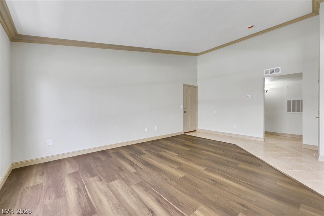 8101 West Flamingo Road, Unit 2136 Las Vegas, NV 89147 - Photo 9 of 32 Rich wood-look flooring transitions to clean tile in this versatile, open living area.