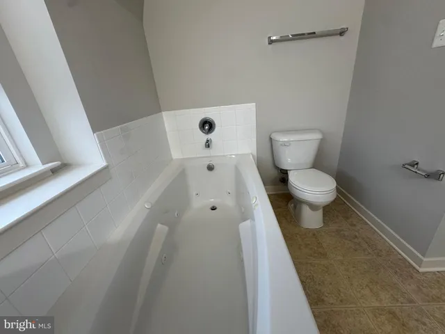 a white toilet sitting next to a white sink