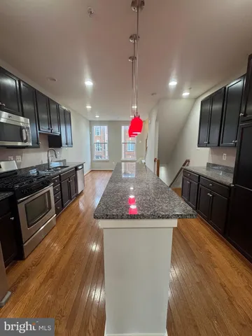 an empty room with wooden floor and fireplace