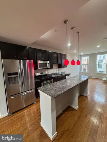 a view of a livingroom with wooden floor and a window