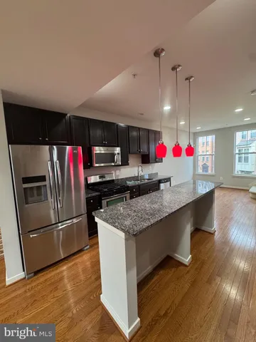 a view of a room with wooden floor and staircase