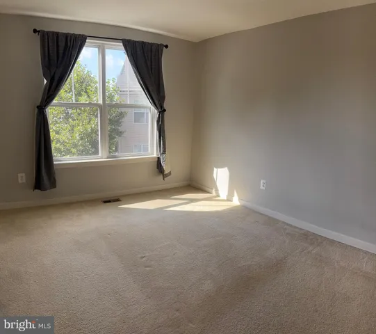 an empty room with a empty space and windows