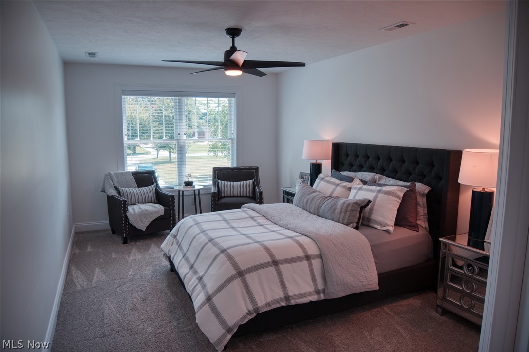 4553 Sharon Copley Road Medina, OH 44256 - Photo 16 of 32 Carpeted bedroom featuring a ceiling fan, a large window with horizontal blinds, and neutral wall tones