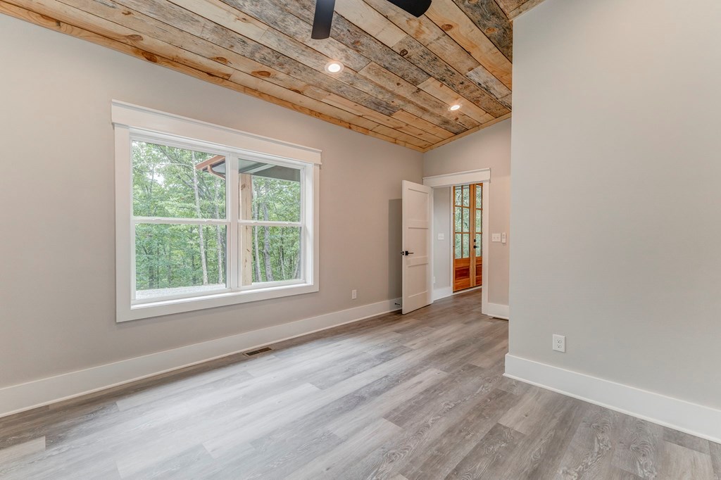 182 Stirratt Road Ranger, GA 30734 - Photo 36 of 82 an empty room with wooden floor and windows