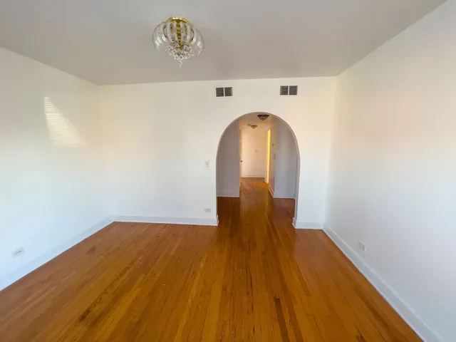 a view of a hardwood floor in a room